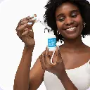 vitamin boost new skin png a woman smiling as she uses the product